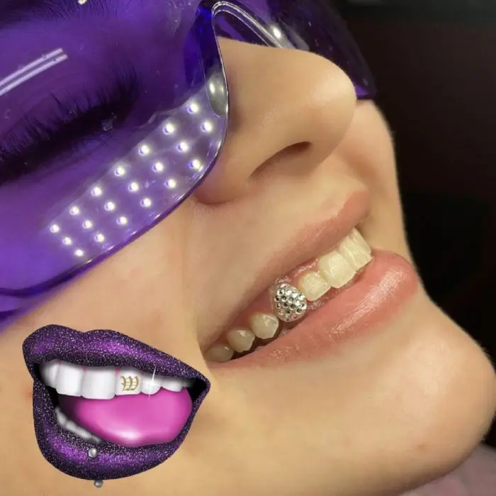 A woman with purple lips and teeth wearing a mask.