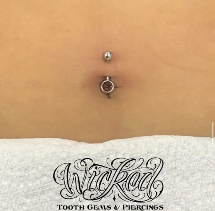 A close up of the belly button piercing