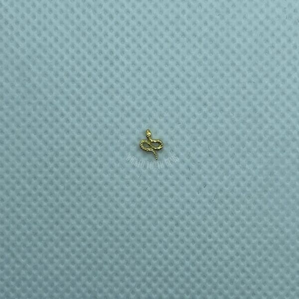 A small yellow object sitting on top of a blue surface.