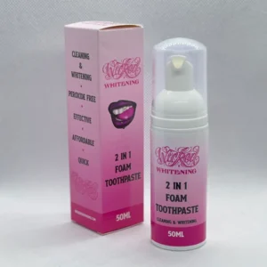 A pink bottle and box of toothpaste