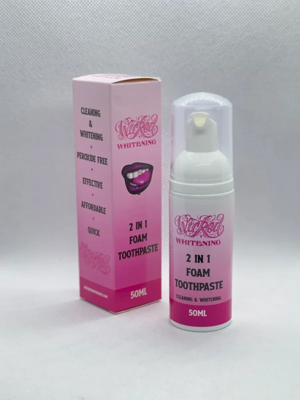 A pink bottle and box of toothpaste