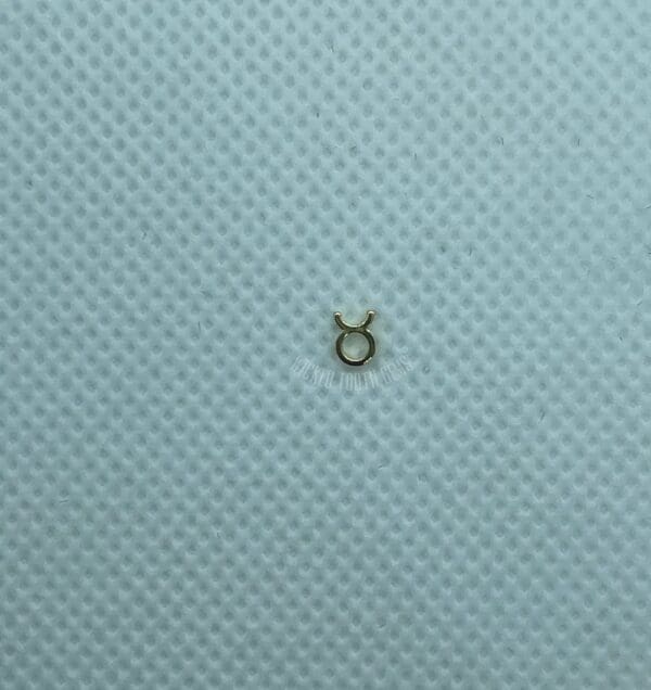 A small metal object sitting on top of a blue surface.