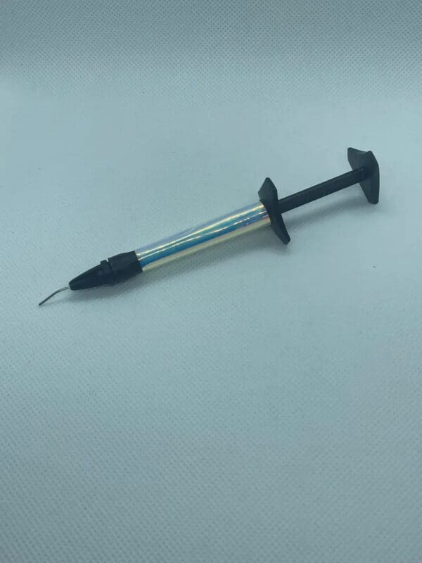 A black and silver pen with a needle in it