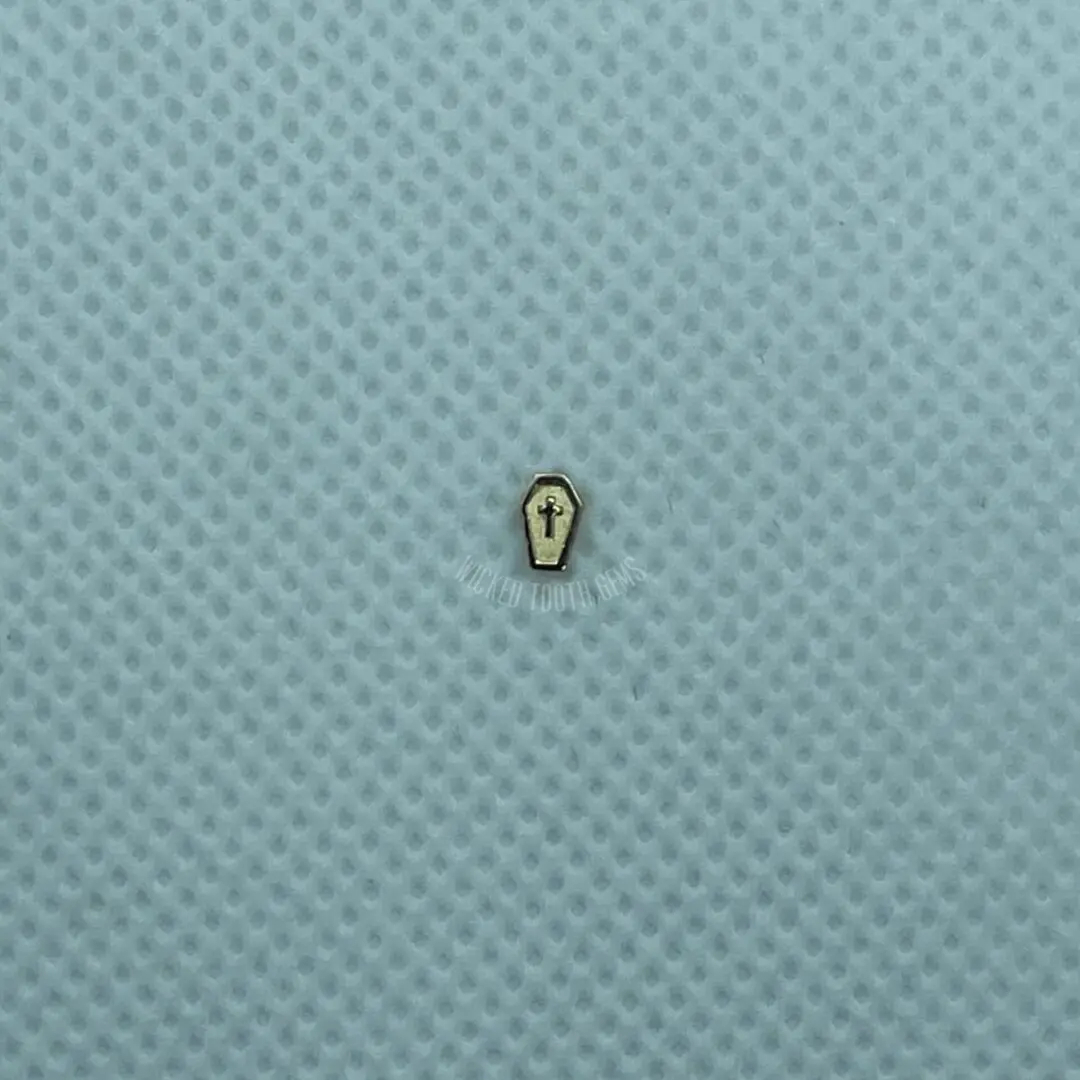 A small gold object sitting on top of a blue surface.