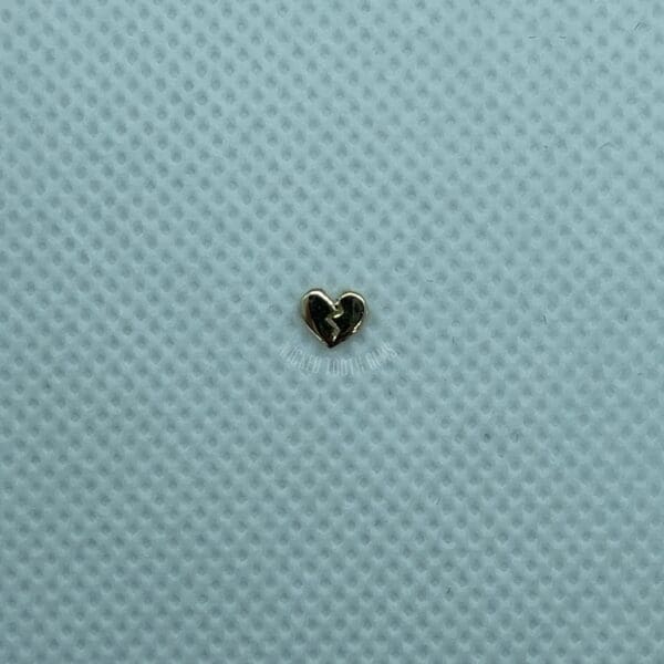 A heart shaped object sitting on top of a blue surface.