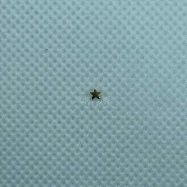 A star is sitting on the surface of a blue cloth.