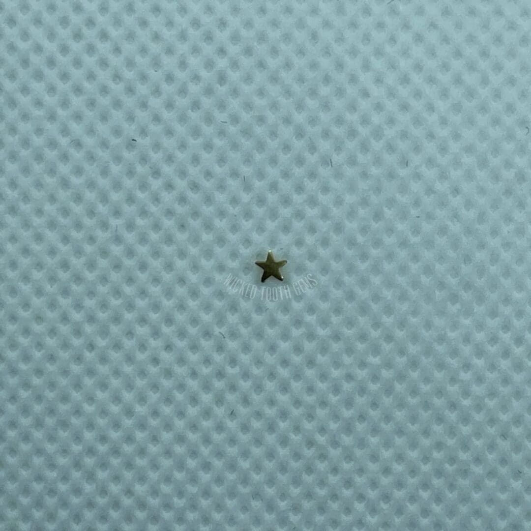 A star is sitting on the surface of a blue cloth.