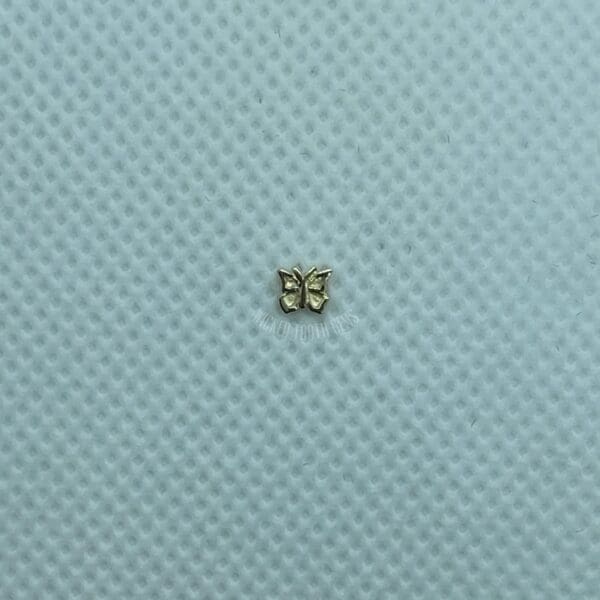 A small butterfly is sitting on top of the blue cloth.