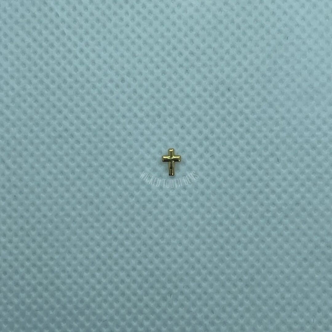 A cross is sitting on top of a blue cloth.