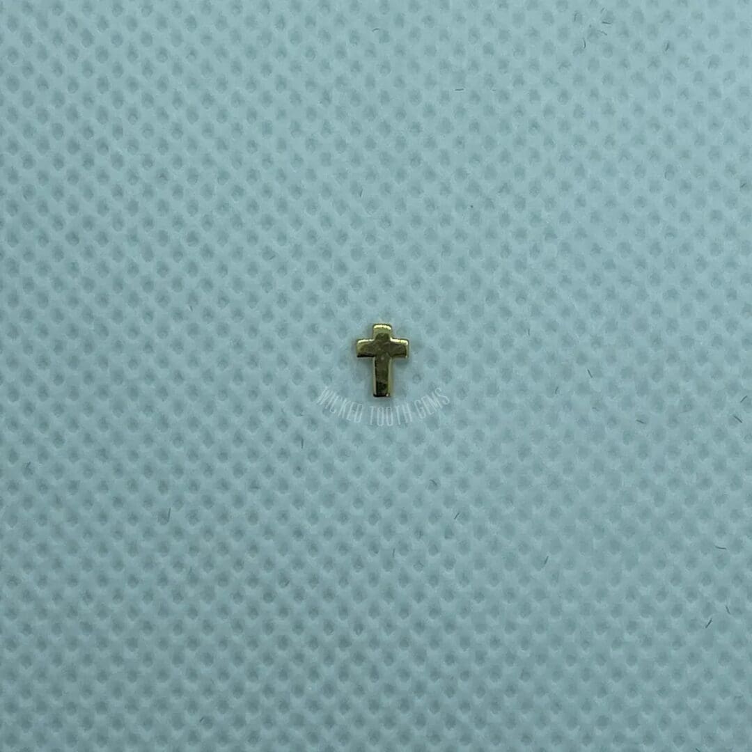 A cross is shown on the fabric of a blue cloth.