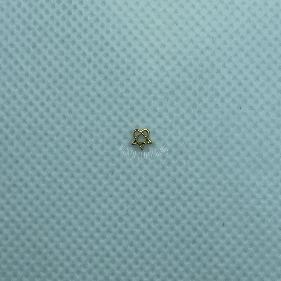 A small piece of cloth sitting on top of a blue surface.