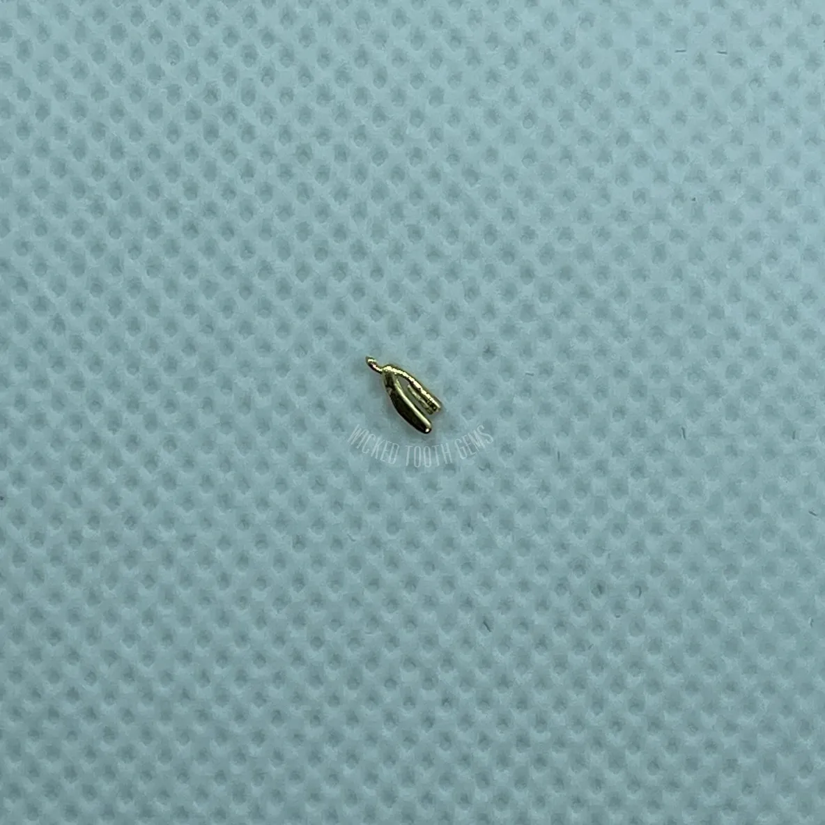 A tiny object is sitting on top of a blue surface.