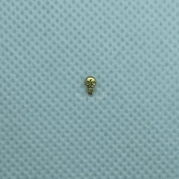 A small gold skull on a blue background.