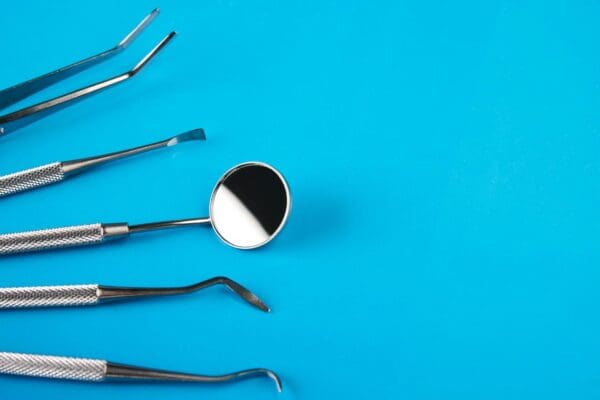 A group of dental instruments on top of a blue table.