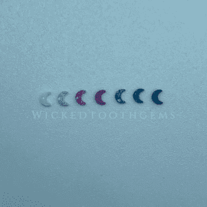 A series of small blue and pink objects on a white surface.