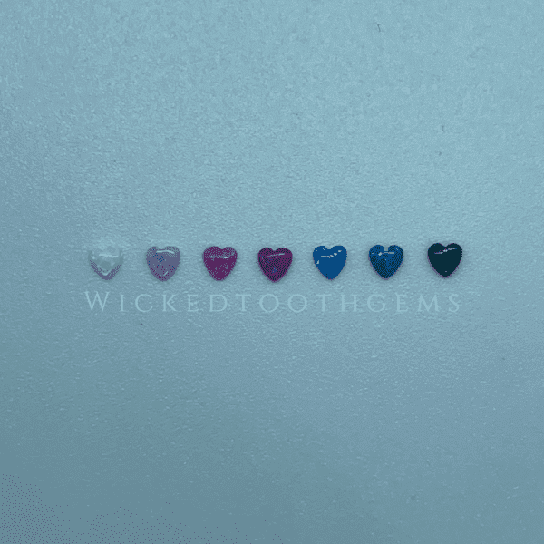 A row of different colored hearts on a blue background.