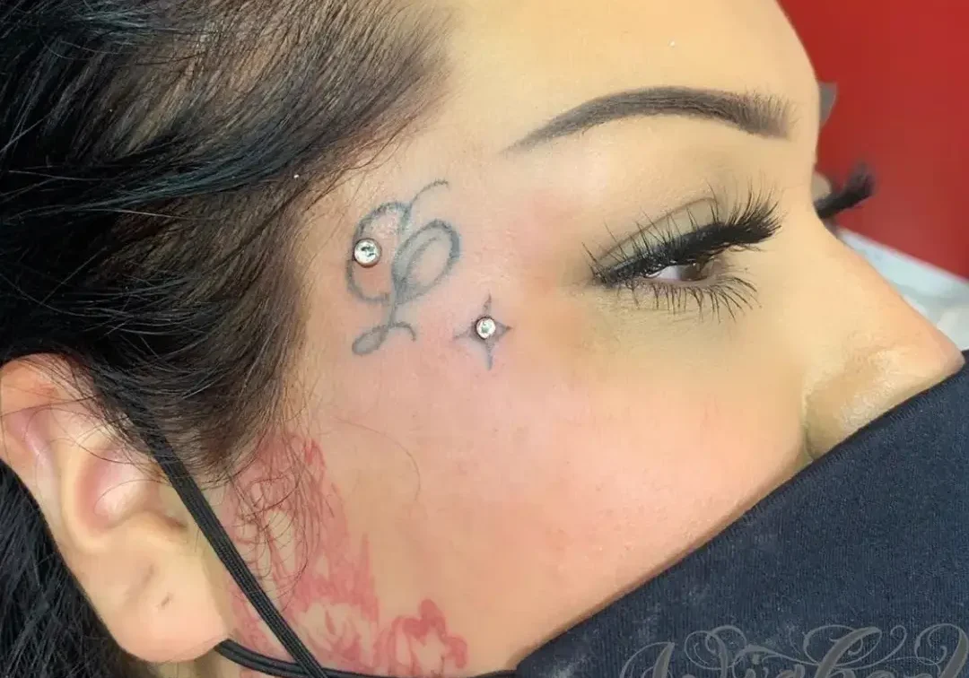 A woman with tattoos on her face and neck.